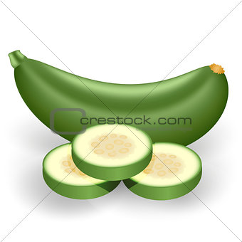 Green zucchini and three cut pieces of zucchini on a white backg