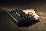 Sacred bible and Holy card with Jesus Christ image on a desk