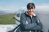 Smiling female pilot posing with her plane
