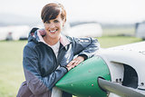 Female pilot posing with her plane