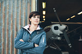 Smiling woman leaning against the hangar walls
