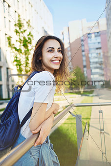portrait of a young attractive woman on the cityscape background