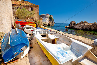 Colorful boat below Dubrovnik defense walls