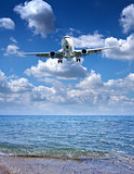 Passenger airplane prepare for landing on sunny sea and sky back