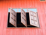 Wooden window is opened from the countryside house.
