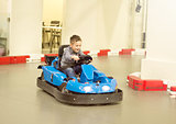 Boy in bumper car driving autoscooter