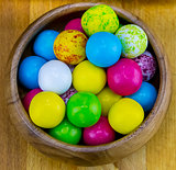 colorful various round candy yellow blue bright dessert in a wooden bowl close-up