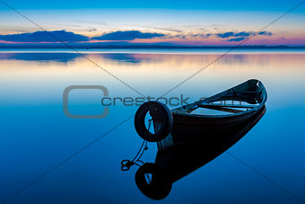 Dawn on lake Seliger with an old fishing boat in the foreground