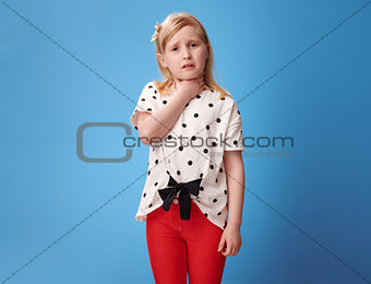 unhappy modern girl in red pants on blue caught cold