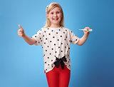 smiling modern girl showing thumbs up and thermometer on blue