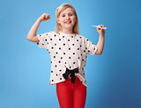 happy modern girl showing biceps and thermometer on blue