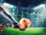Soccer player with soccerball on fire at the stadium during the match