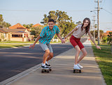 brother and sister with  skateboard