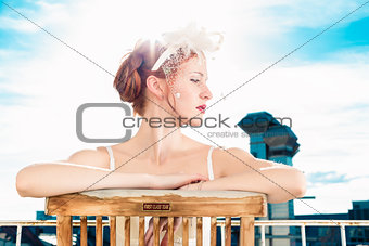 Bride with bridal lingerie sitting on balcony