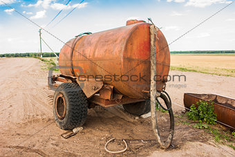 trailer with water for cattle on the field
