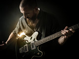 Bearded man playing bass guitar