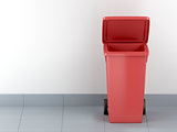 Red plastic waste container