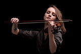 passionate violin musician playing on black background