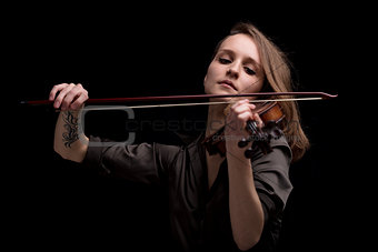passionate violin musician playing on black background