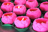 Burning candles in candlesticks in the form of a lotus