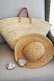  Closeup of straw hat and purse in chair                        