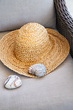  Straw hat with heart shaped rocks on chair                     