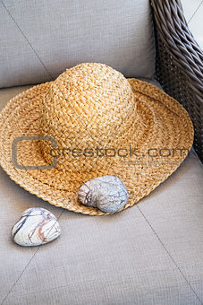  Straw hat with heart shaped rocks on chair                     