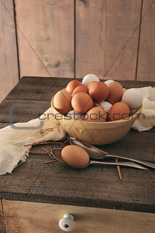 Fresh eggs on rustic wooden table