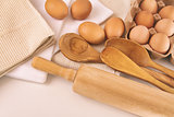 Top view of fresh eggs and utensils on table