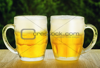Two glasses of beer on wooden table