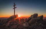 Cross on Mountain Peek at Sunset