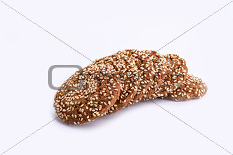 Isolated on white. Several oatmeal cookies with sesame seeds