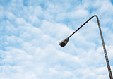 Street light pole under the couldy sky.