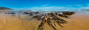 Rock formations on sandy beach (Portugal).