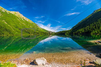 Blue Lake Morskie Oko and the green mountains of Tara, Poland