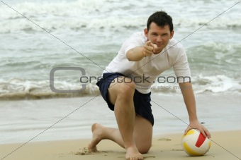 Man with volleyball on the beach