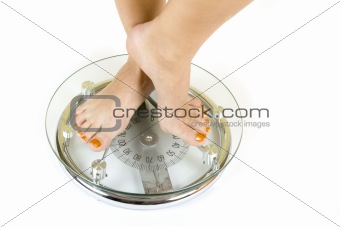feet on white glass scale