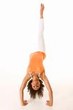 Woman performing aerobic stretching stunt with one leg up in the
