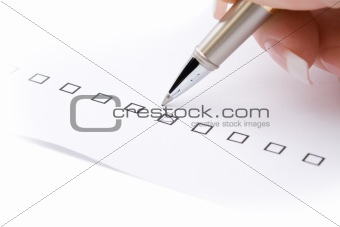 Woman hand marking a check box