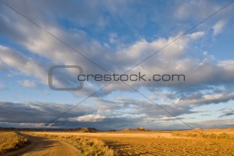 Lonely road under cloudy sky