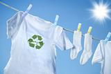 T-shirt with recycle logo drying on clothesline on a hot summer day