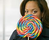 Woman Peeking Out From Behind A Lollipop