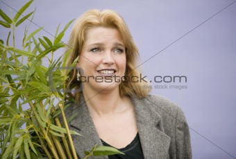 Woman carrying a plant