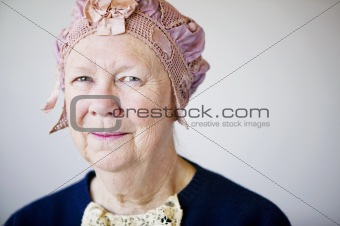 Smiling senior woman with a vintage hat