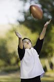 Boy catching a football