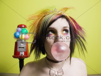 Punk Girl in front of a Green Wall Blowing a Bubble