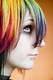 Alternative girl with multi-colored hair looks up