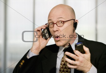 Businessman with multiple cell phones