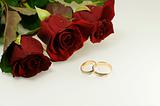 tree red roses with two wedding rings