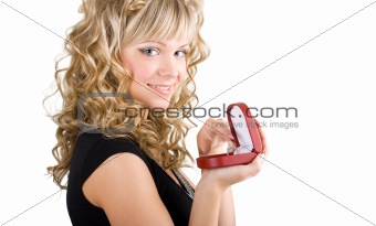 Friendly blond girl holding a wedding ring